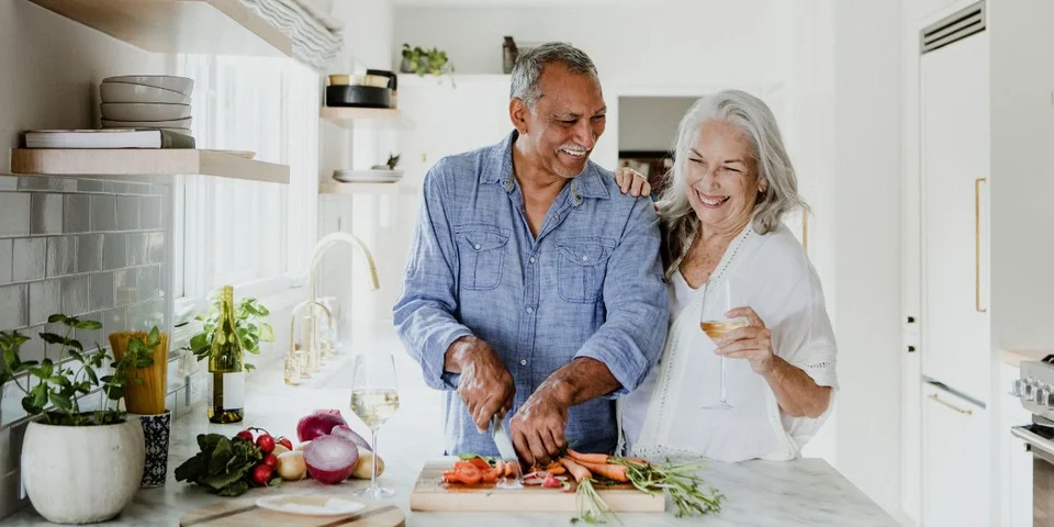 A couple enjoing cooking after 50