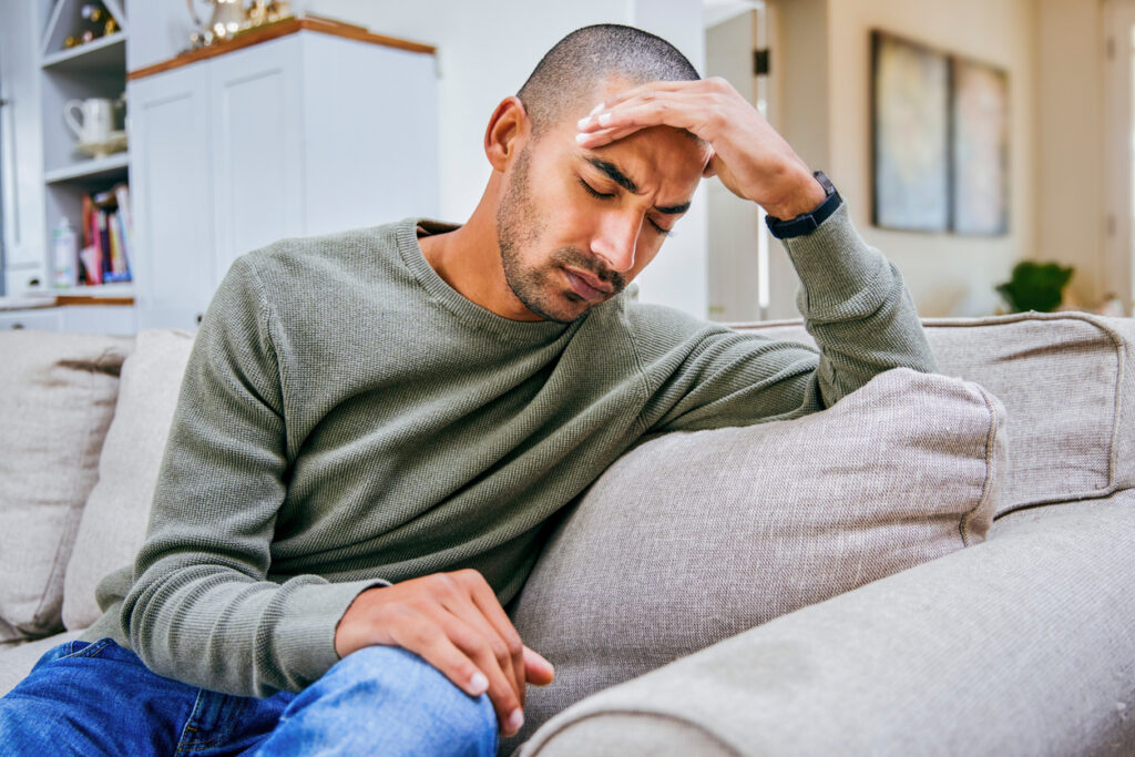 headaches after 50 person holding head in discomfort at home