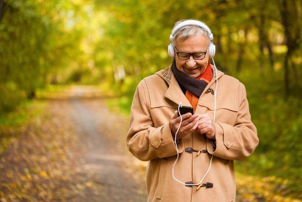 Older adult listening to an audiobook while walking outdoors