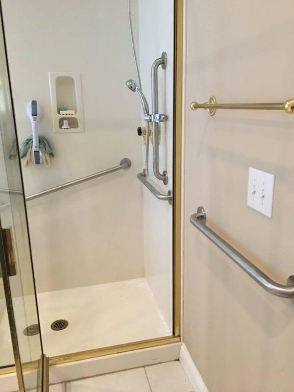 Shower grab bars for seniors installed in a walk-in bathroom shower for added safety and stability.
