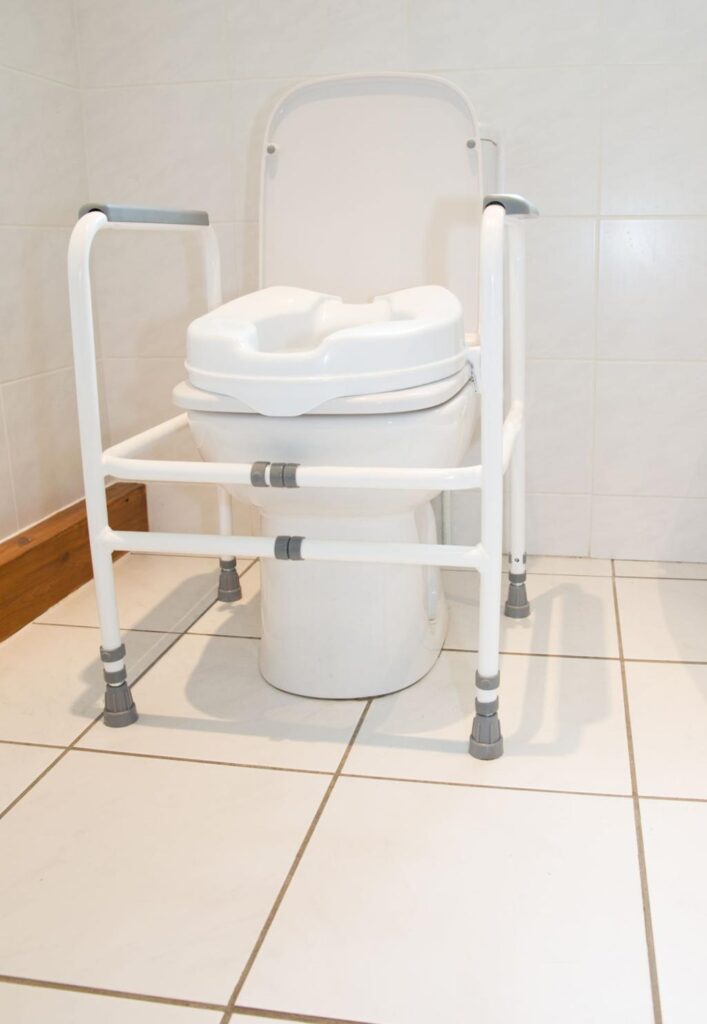 Toilet seat riser for seniors installed on a bathroom toilet to improve comfort, safety, and ease of use.