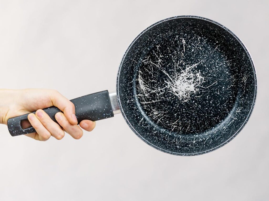 Scratched nonstick frying pan showing signs of wear on the cooking surface.