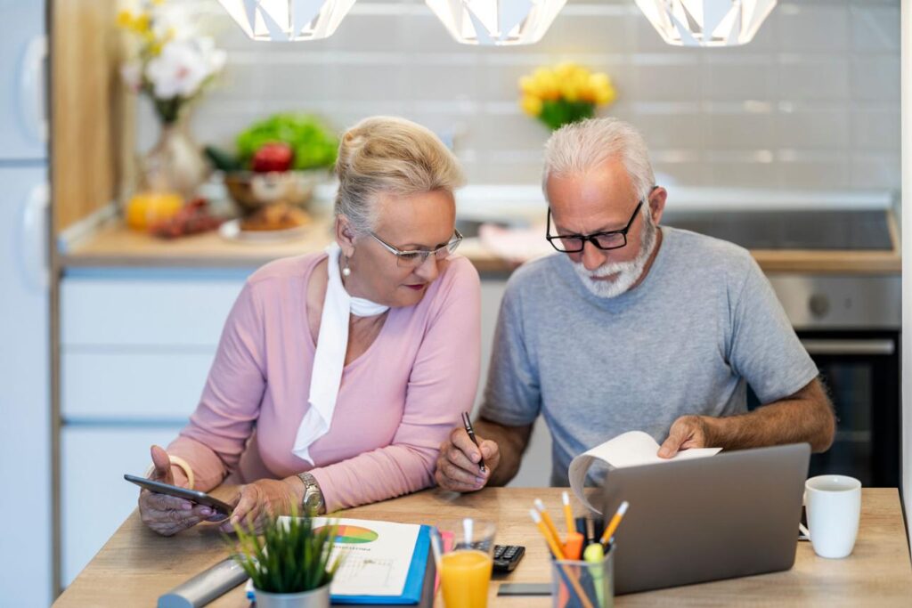 Adults over 50 reviewing household finances and planning for a secure future.